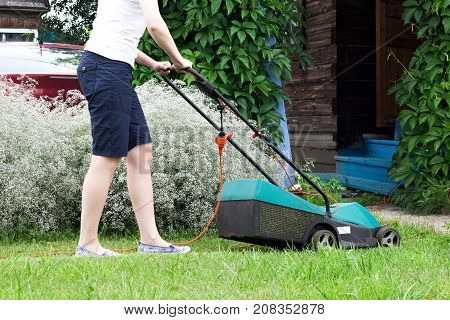 Lawn Mower at Work in garden .