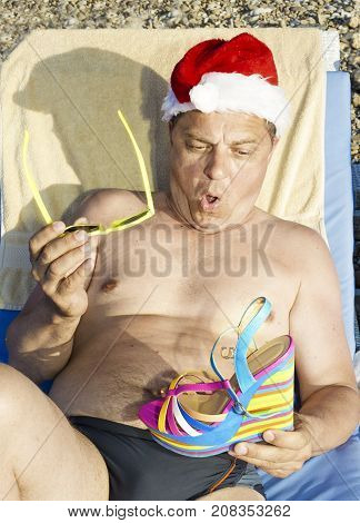 Santa Claus Is Resting On The Sunset On The Beach