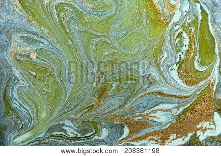 Marbled blue abstract background with golden sequins. Liquid marble ink pattern