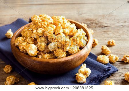 Homemade Caramel Popcorn In Wooden Bowl Close Up
