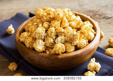 Homemade caramel popcorn in wooden bowl. Caramel popcorn