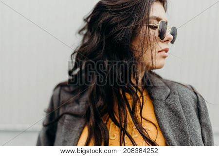 Portrait Of Stylish Modern Young Curly Woman In Coat Sunglasses
