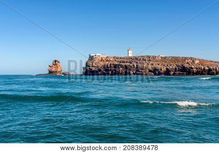 Nau dos Corvos and the Lighthouse of Peniche, Portugal. View from the ocean