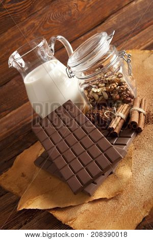 Milk Chocolate, Cocoa, Cinnamon Sticks And Nuts In A Jar