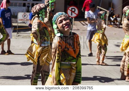 16 Sep 2017 Dumaguete Philippines - smiling actor of Sandurot festival. Philippines festival tradition. Street performance actress smiling in camera. Street dance parade in national costume