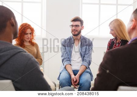 Meeting of support group. Happy man talking about his life, everything good. Mental health, psychotherapy concept