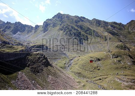 Red cable car in the mountains over the road- Carphatians