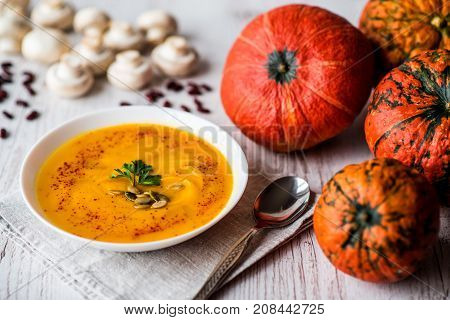Pumpkin soup with seeds and parsley. Vegan food.