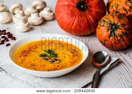 Pumpkin soup with seeds and parsley. Vegan food.