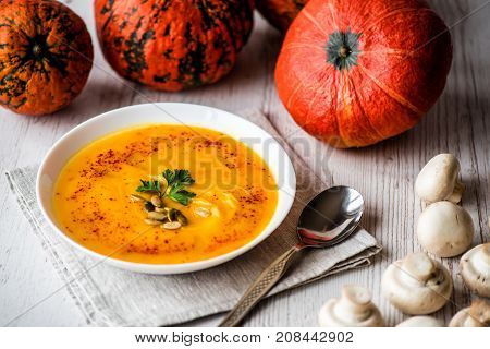 Pumpkin soup with seeds and parsley. Vegan food.