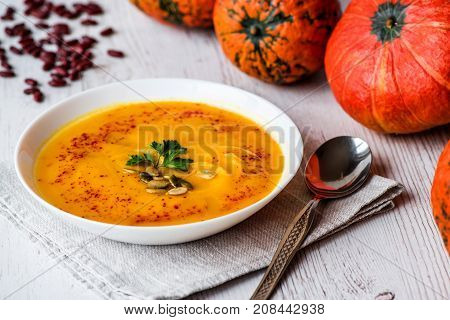 Pumpkin soup with seeds and parsley. Vegan food.