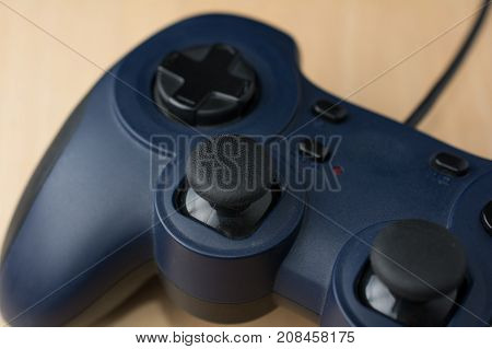 Video Game Controller on Wood Background Close Up Perspective View