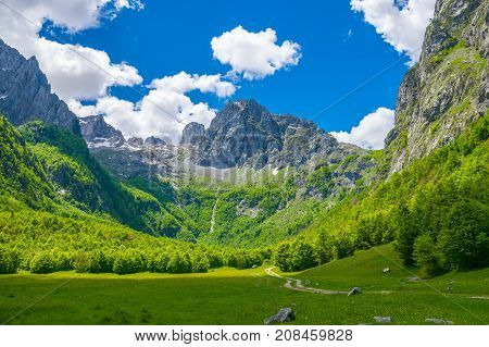 Picturesque Meadows And Forests Are Located Among The High Mountains.