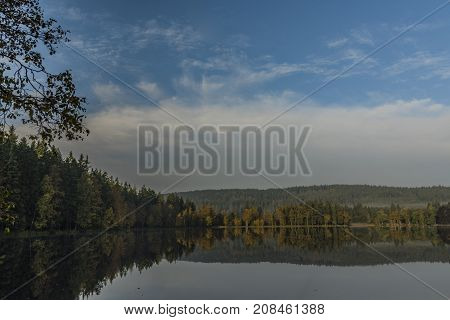 Blue morning near Kladska pond in autumn time with fog