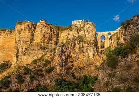 View at the rocks with El Tajo gorge with bridge (Puente Nuevo)in Ronda - Spain