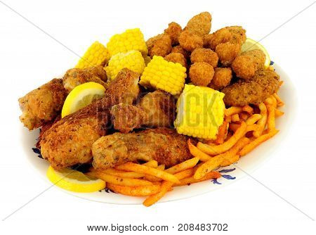 Plate of Southern fried chicken products with sweetcorn and fries