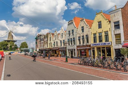 LEIDEN, NETHERLANDS - SEPTEMBER 03, 2017: Shopping street and old windmill in Leiden Holland