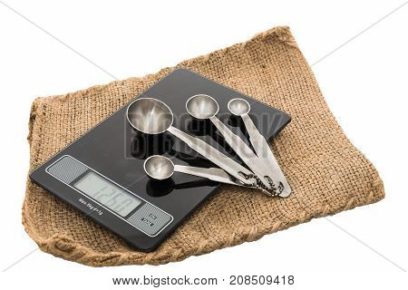 Measuring spoons and food scale used to calculate the mixture to a standard .