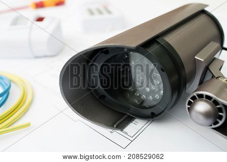 Still Life Of Home Security Products Arranged On House Plans