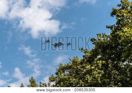 Madrid Spain - October 12 2017: Two F18 Hornet and two F5 jet fighters flying in Spanish National Day Parade. Several troops take part in the army parade for Spain's National Day.