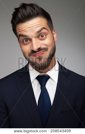 this business man has no clue about anything in the real world; man blowing his cheeks