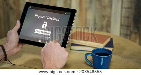 Payment declined and limit reached text on phone screen against man using digital tablet in coffee shop