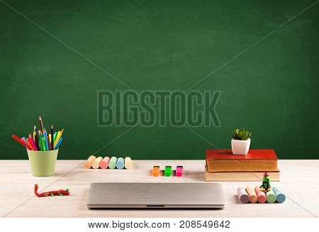 Back to school concepty with clear blackboard background, desk, items