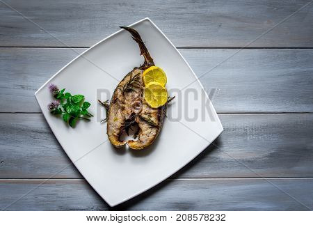 Grilled yellowtail amberjack just cooked fillets with lemon slices.