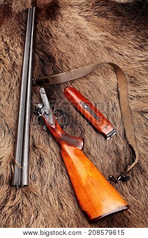 Old Double-barreled Shotgun, Disassembled, Gun On Wild Boar Furs.top View. Copy Space