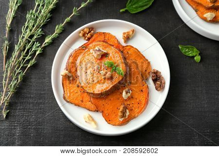 Plate with cooked sweet potato on table