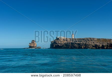 Nau dos Corvos and the Lighthouse of Peniche, Portugal. View from the ocean
