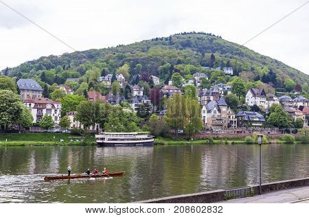 Neckar river in Heidelberg city Baden-Wurttemberg state Germany. Philosophenweg on the background. Spring cloudy day