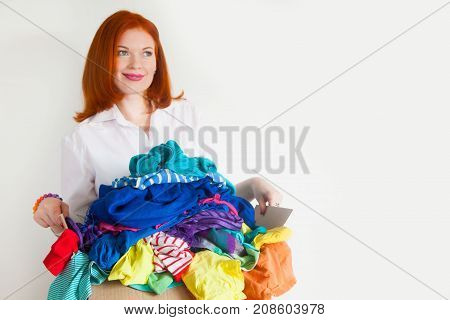 A Woman Is Busy With The Clutter In Her Wardrobe.