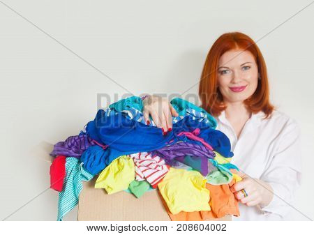 A Woman Is Busy With The Clutter In Her Wardrobe.