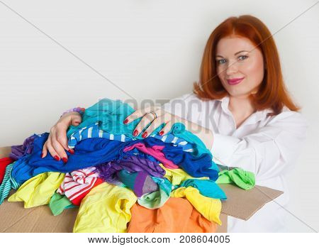 A Woman Is Busy With The Clutter In Her Wardrobe.
