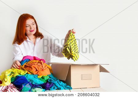 A Woman Is Busy With The Clutter In Her Wardrobe.