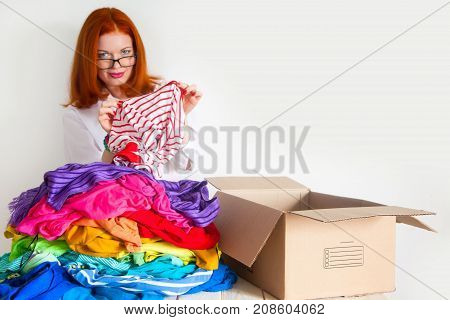 A Woman Is Busy With The Clutter In Her Wardrobe.