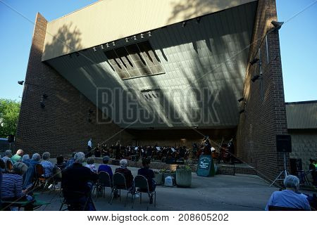 JOLIET, ILLINOIS / UNITED STATES - JUNE 1, 2017: The Metropolitan Youth Symphony Orchestra (MYSO) prepares to perform a free public concert at the outdoor theater in the Billie Limacher Bicentennial Park.