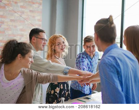 Office workers join hands to raise the spirit of work so that the work goes well. Business and finance concept.