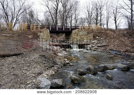 A bridge, along the Little Traverse Wheelway, which connects Charlevoix, Petoskey and Harbor Springs, Michigan, allows hikers and bicyclists to cross Tannery Creek.