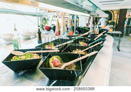 Salad black bowls with fresh vegetables buffet breakfast