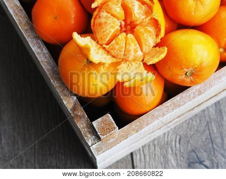Fresh Tangerines In An Old Box With Leaves. On Wooden Background. Top View