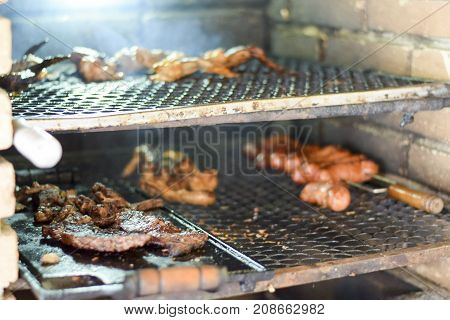 Brazilian Man Tending To Churrasco