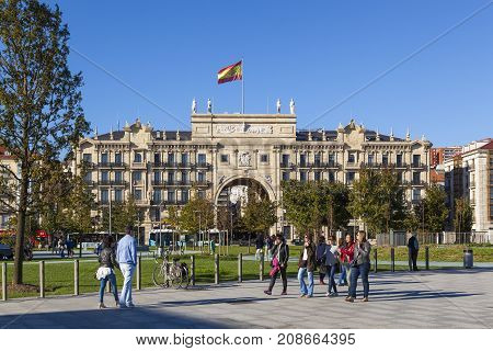 SANTANDER SPAIN - OCTOBER 7 2017: Tourists stroll on the Paseo Pereda boulevard in front of the heaquarters building of Banco de Santander.