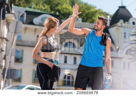 Sportswoman And Sportsman Giving Highfive