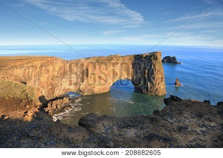 Rocks formation on Dyrholaey cape with black sand beach near Vik town Iceland in autumn on sunny day