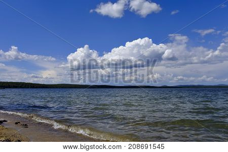 Bright Clouds Reflected In The Water