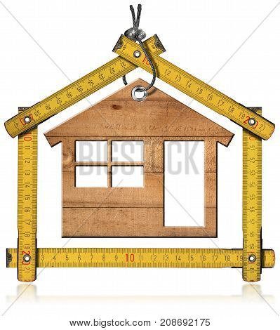 Yellow folding ruler in the shape of house with a wooden model house. Isolated on white background. Construction industry concept