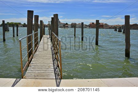 A mooring pier and mooring piles in the Dorsoduro quarter of Venice. The island of Giudecca can be seen across the Giudecca canal.