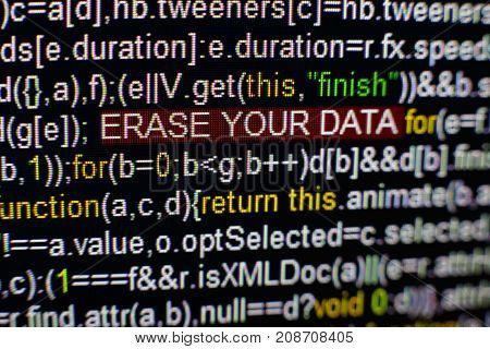 Macro photo of computer screen with program source code and highlighted SPYWARE inscription in the middle. Computer script on the screen with virus in it. Cyber security concept.